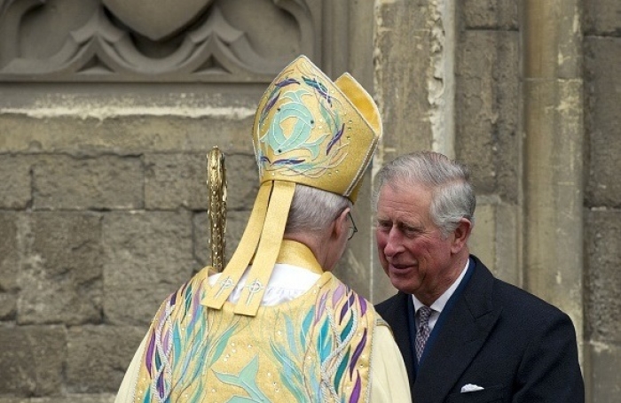 The Prince of Wales, now King Charles III, speaks to the Archbishop of Canterbury Justin Welby, primate of the Church of England, at Canterbury Cathedral in 2013. (Photo by Adrian Dennis / AFP via Getty Images)