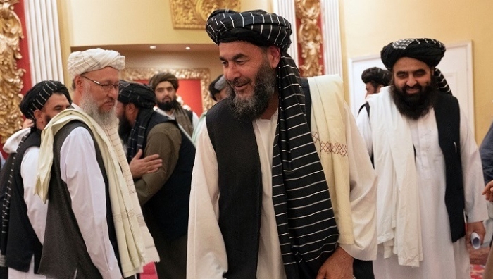 Drug lord and Taliban associate Bashir Noorzai, freed from imprisonment in the U.S., is welcomed in Kabul by senior regime leaders. Behind him are Taliban foreign minister Amir Khan Muttaqi, right, and deputy prime minister Abdul Salam Hanafi, left. (Photo by Wakil Kohsar / AFP via Getty Images)