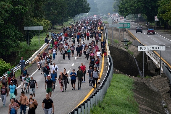 A caravan of people heading to the U.S. marches from Huixtla to Escuintla, Chiapas state, Mexico, on June 9, 2022. (Photo by PEDRO PARDO/AFP via Getty Images)