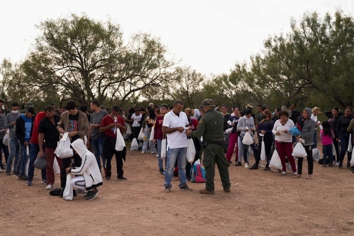 Migrants are processed by US Border Patrol after they illegally crossed the US southern border with Mexico on October 9, 2022 in Eagle Pass, Texas. (Photo by ALLISON DINNER/AFP via Getty Images)
