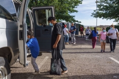 Families board vans to depart to the El Paso International Airport, where they will fly to their final destinations, at a motel used as a temporary shelter by the non-profit Colores United in Deming, New Mexico on June 5, 2022. (Photo by PAUL RATJE/AFP via Getty Images)