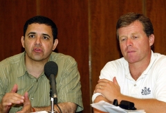 United States Congressman Henry Cuellar, D-TX, (L) speaks with journalists as Charlie Dent (R) of Pennsylvania looks on at the Al Rashid hotel in central Baghdad 18 August 2005. The Congressional delegation, on a 2-day visit to Iraq, spent time in the south inspecting Iraq's small navy, and in the northern oil rich city of Kirkuk visiting oil installations. They will also meet with troops from their respective states. (Photo by CEERWAN AZIZ/AFP via Getty Images)
